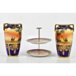 NORITAKE: a pair of hand painted twin handled vases decorated with desert scenes with jewelled
