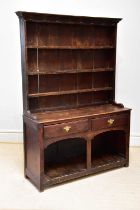 A George III oak dresser, with plate rack above two drawers and two alcoves, height 192cm, width