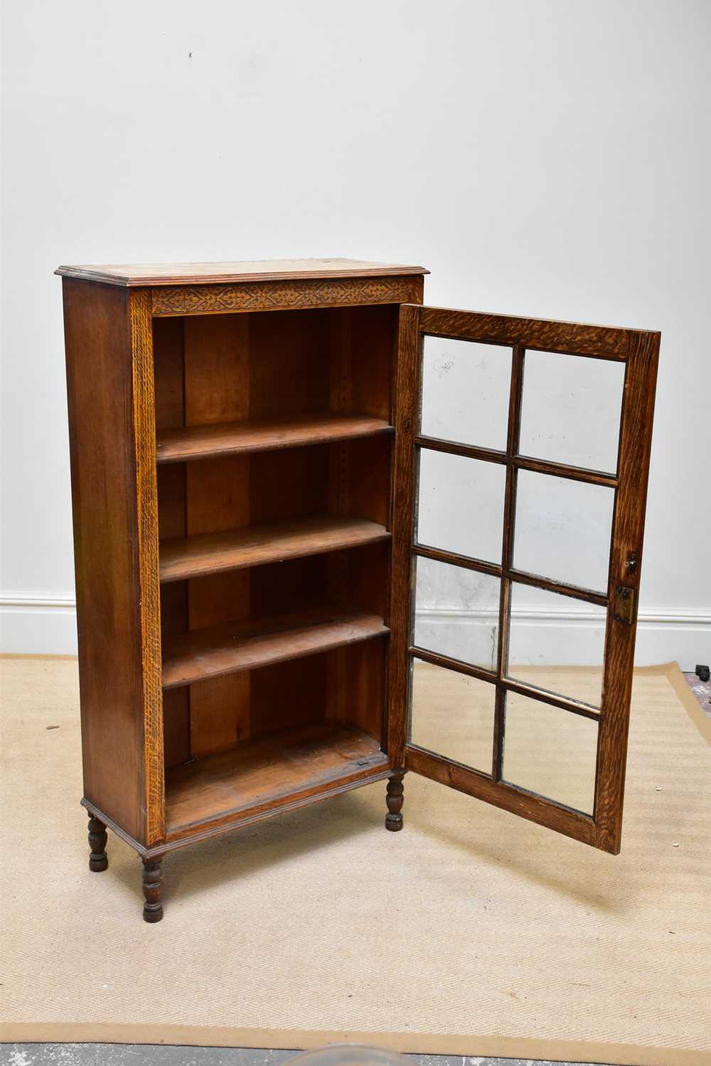 A 1930s oak display cabinet, with glazed door enclosing shelves, on turned legs, height 141cm, width - Image 2 of 3