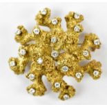A large yellow metal brooch set with twenty small diamonds, approx 26.5g.