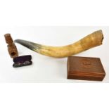 A large cow horn, a pair of spectacles, a modern carved box and a nut cracker.