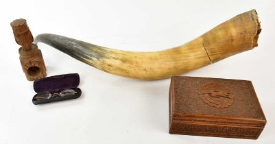 A large cow horn, a pair of spectacles, a modern carved box and a nut cracker.