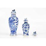 Two 19th century blue and white Chinese lidded vases and covers both with character marks to the