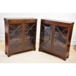 A pair of Waring & Gillow mahogany bookcases, each with astragal glazed doors, on bracket feet,