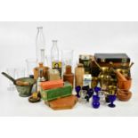 A collection of pharmaceutical items including test tubes, measuring glasses, eye baths, pestles and