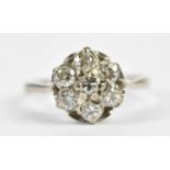 An 18ct white gold seven stone diamond flowerhead ring, each stone weighing approx. 0.20cts, size K,