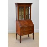 An Edwardian inlaid mahogany bureau bookcase of small proportions with moulded cornice above the two