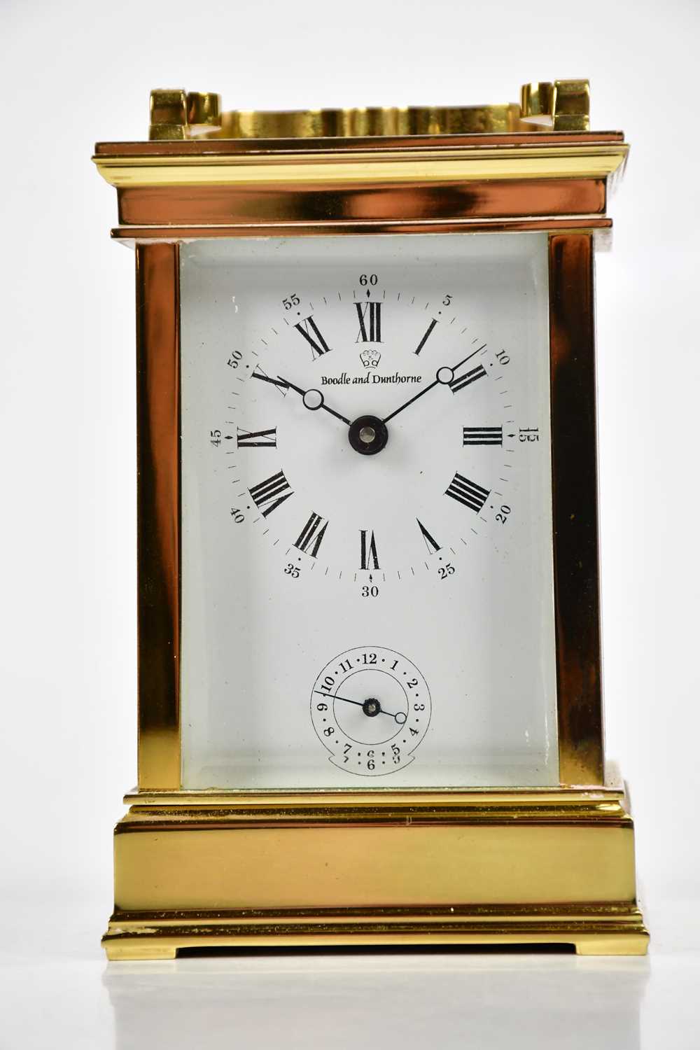 BOODLE & DUNTHORNE; a French brass cased carriage clock/timepiece, the enamel dial set with Arabic