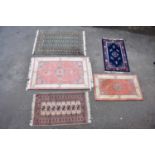 Five decorative modern rugs including a green ground example with elephant foot decoration, two