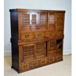 A 20th century Chinese elm cabinet of large proportions with an arrangement of sliding doors and