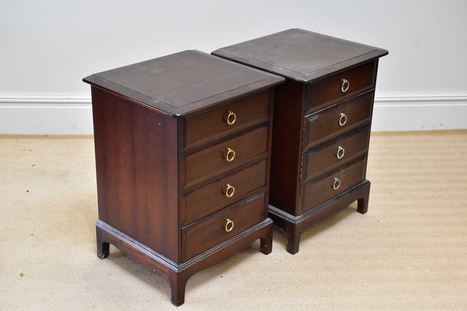 STAG MINSTREL; a pair of four drawer bedside chests on bracket feet, height 70cm, width 54cm,