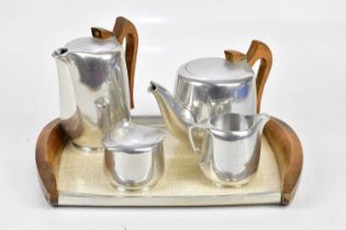 PICQUOT WARE; a four piece tea set with wooden handles and wooden mounted tray, length of tray