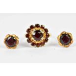 An 18ct yellow gold garnet set dress ring, size K, approx 4g, and a pair of yellow metal garnet