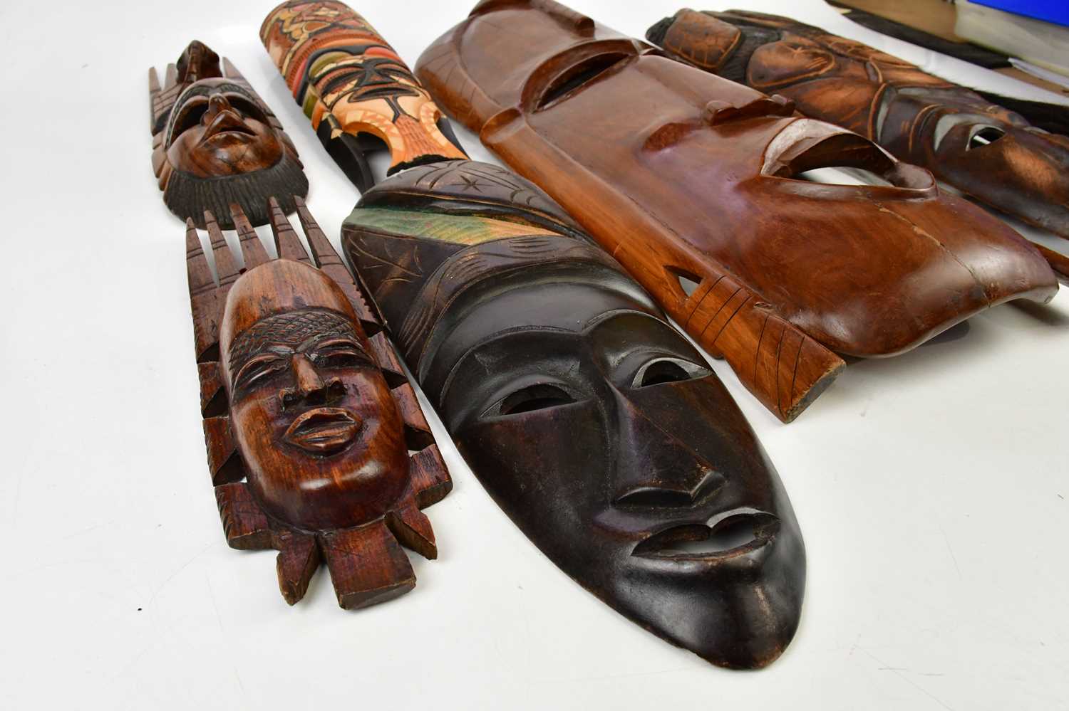 A collection of six decorative African masks, largest 63cm, together with animal hair fly swatter. - Image 2 of 5