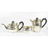 HARRODS LTD; a George V hallmarked silver three piece tea service, comprising teapot, hot water