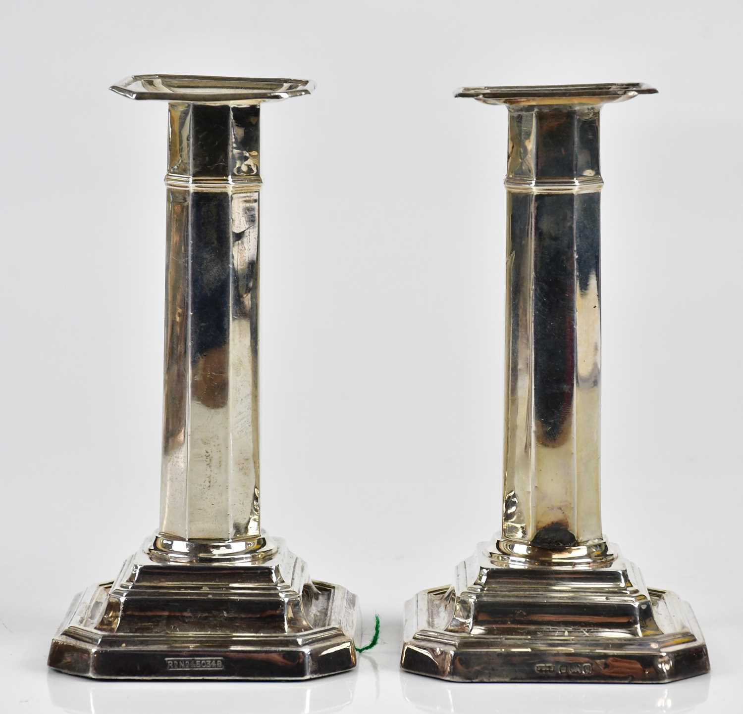 JAMES DIXON & SONS; a pair of Edward VII hallmarked silver candlesticks with octagonal columns,
