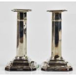 JAMES DIXON & SONS; a pair of Edward VII hallmarked silver candlesticks with octagonal columns,