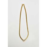 A yellow metal diamond set necklace stamped 750, set with a central brilliant cut diamond, approx