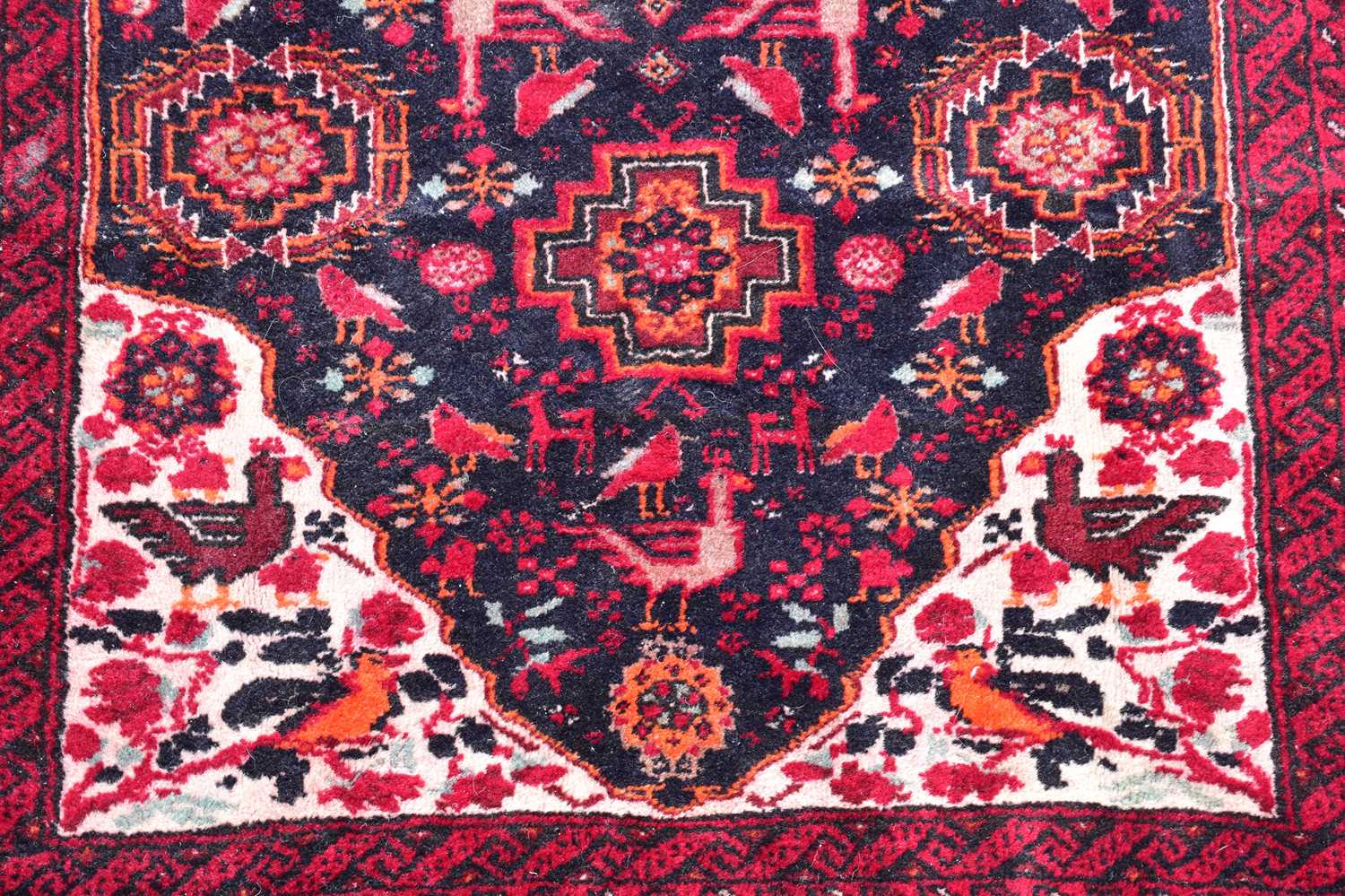 A red ground wool carpet with geometric pattern to the centre, 200 x 100cm. - Image 2 of 3