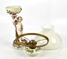 An early 20th century Continental porcelain oil lamp with milk glass dome shade and detachable