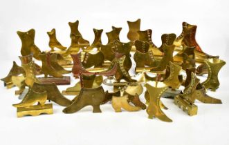 A large collection of brass mantel shelf boots, approx twenty-six pairs.
