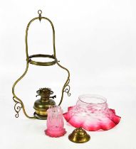 A Victorian brass hanging oil lamp, with large cranberry/clear glass shade with wavy rim, diameter