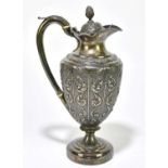 A Georgian hallmarked silver wine ewer, with cast and repoussé decoration of scrolls and foliates,