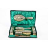 JOSEPH GLOSTER; an Edward VII hallmarked silver five piece dressing table set embossed with