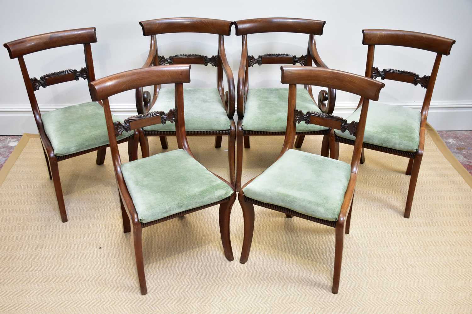 A set of six Regency mahogany bar back dining chairs with drop-in seats and sabre legs (4+2).