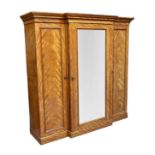 HEAL & SON, LONDON; a Victorian satin birch breakfront triple door wardrobe with moulded cornice, on