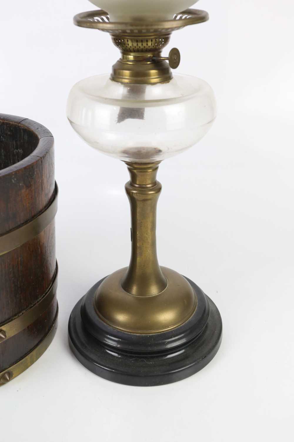 A 20th century brass oil lamp with replacement frosted glass shade and clear glass reservoir, height - Image 3 of 4