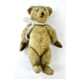 A vintage teddy bear with pointed snout, length 45cm.