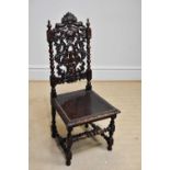 An early 20th century carved oak Carolean style hall chair.