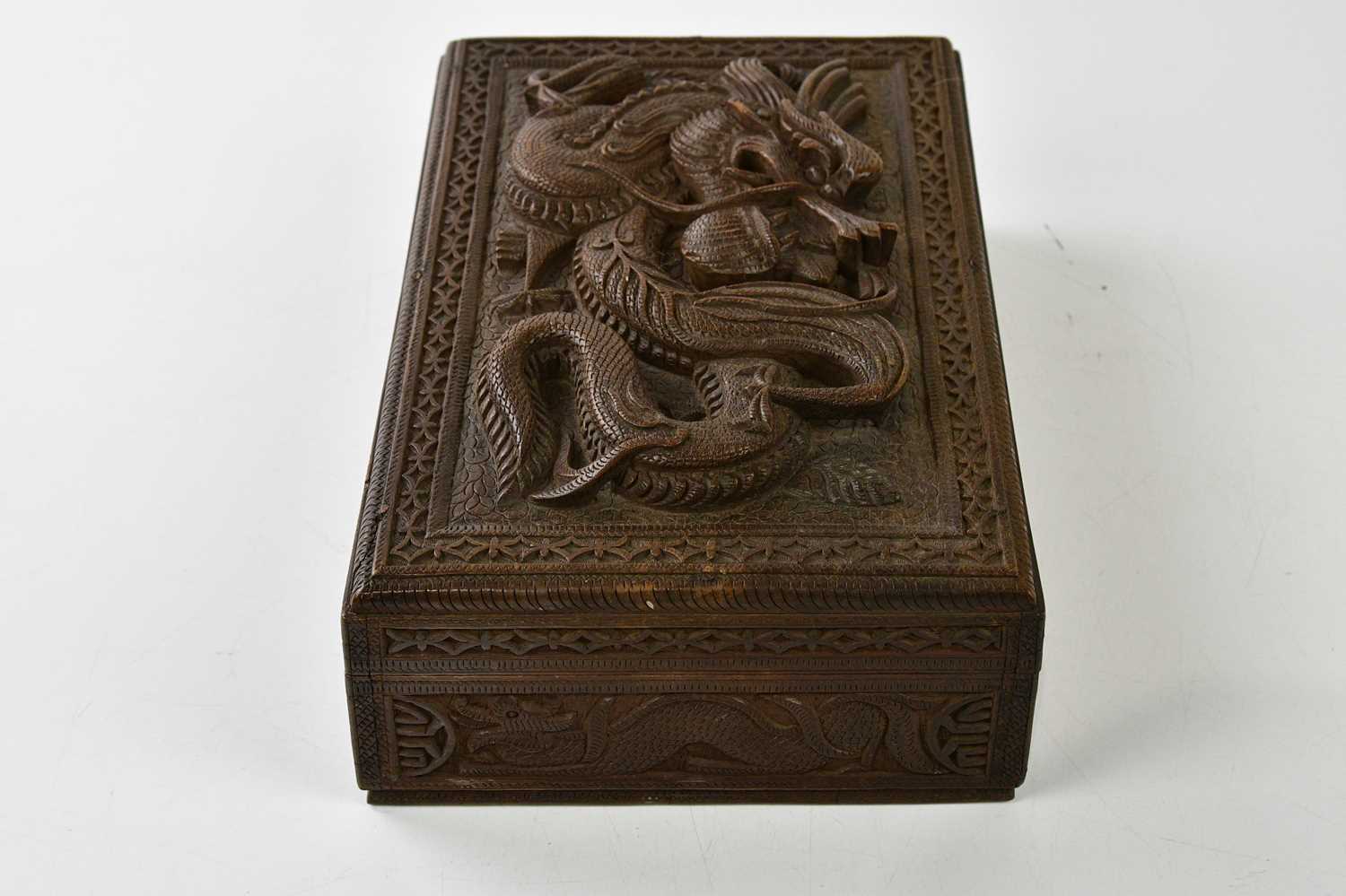 A Chinese hardwood carved box with stylised dragon in relief, height 8cm, width 28cm, depth 18cm. - Image 3 of 4