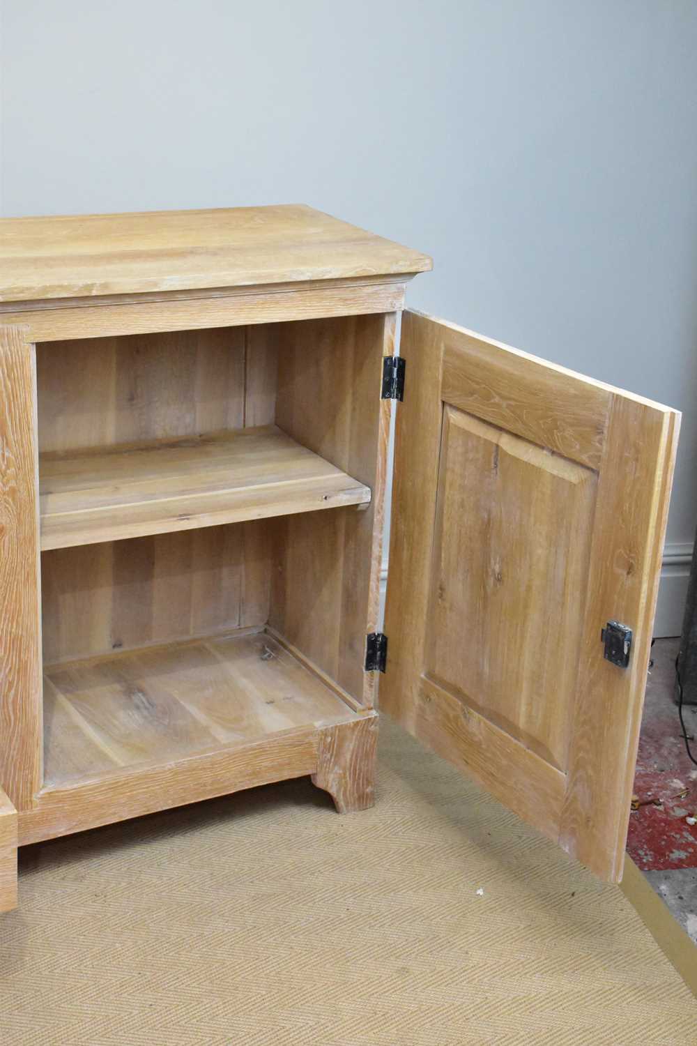 A modern limed oak sideboard with four drawers flanked by panelled cupboard doors, length 216cm, - Image 5 of 5