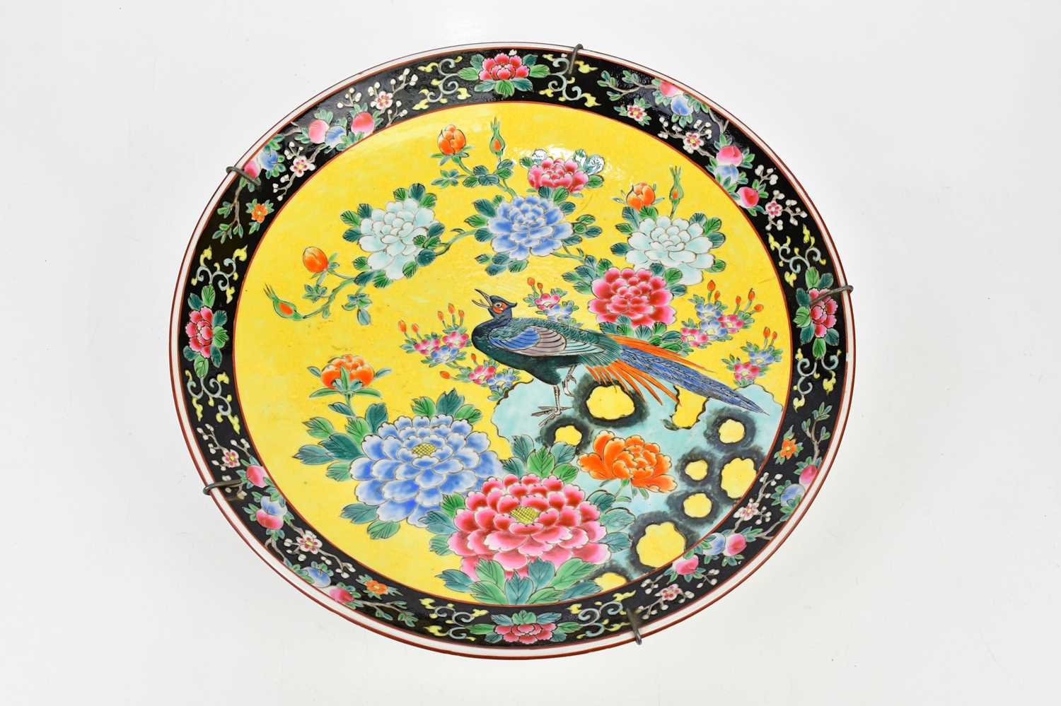 A large 20th century Japanese Famille Noire wall charger, decorated with peacock, diameter 46cm.