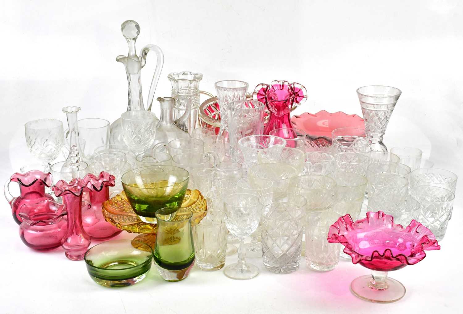 A collection of Victorian and later glassware, including a cranberry glass vase, various cut