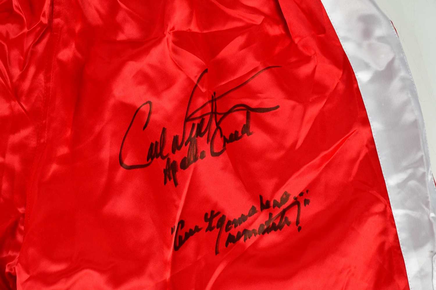 CARL WEATHERS (APOLLO CREED); a pair of red and white signed boxing shorts, inscribed 'There ain't - Image 2 of 2