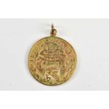 A 9ct yellow gold medallion dated 1875-1913, weight 8.7g.