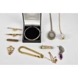 An assortment of costume jewellery including a sterling silver hinged snap bangle, a Victorian