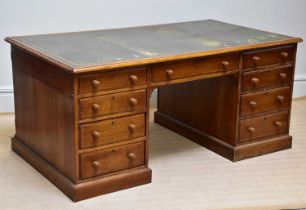 A 19th century oak partner's desk with gilt tooled leather top, drawers and cupboard doors, width
