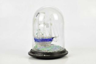 A Victorian glass frigget in a dome, height 23cm.
