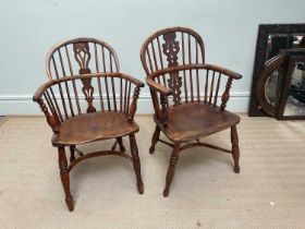 A near pair of 19th century elm and yew wood Windsor elbow chairs, with crinoline stretchers.