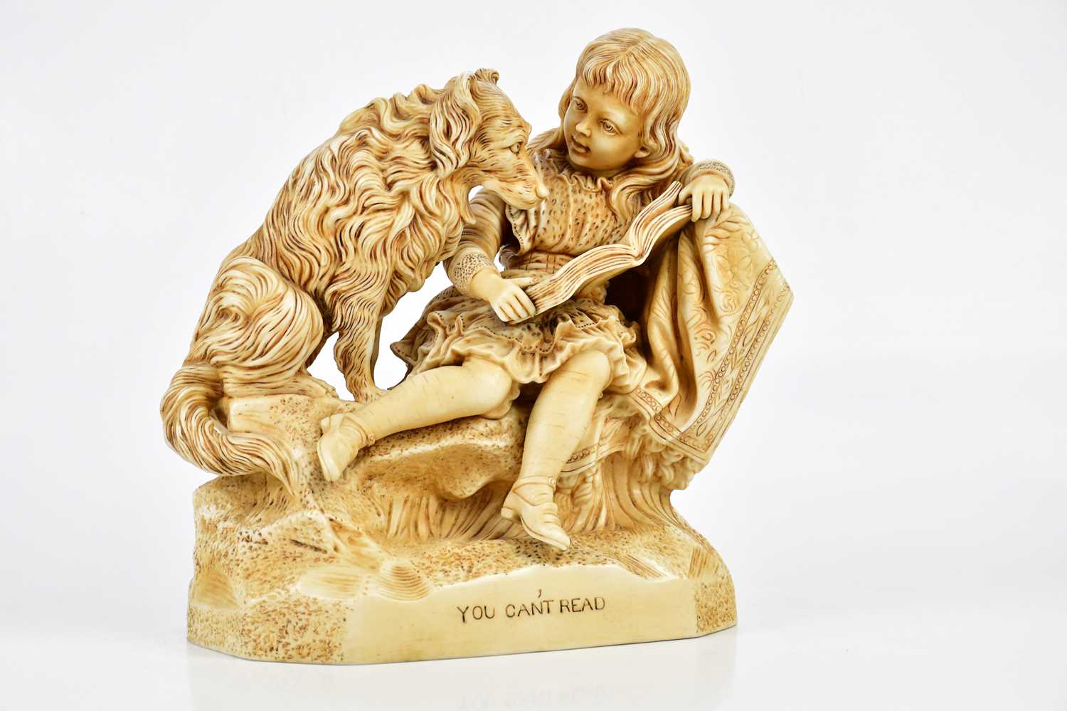 A late Victorian painted Parian figure of a girl beside a dog, 'You can't read', height 30cm.