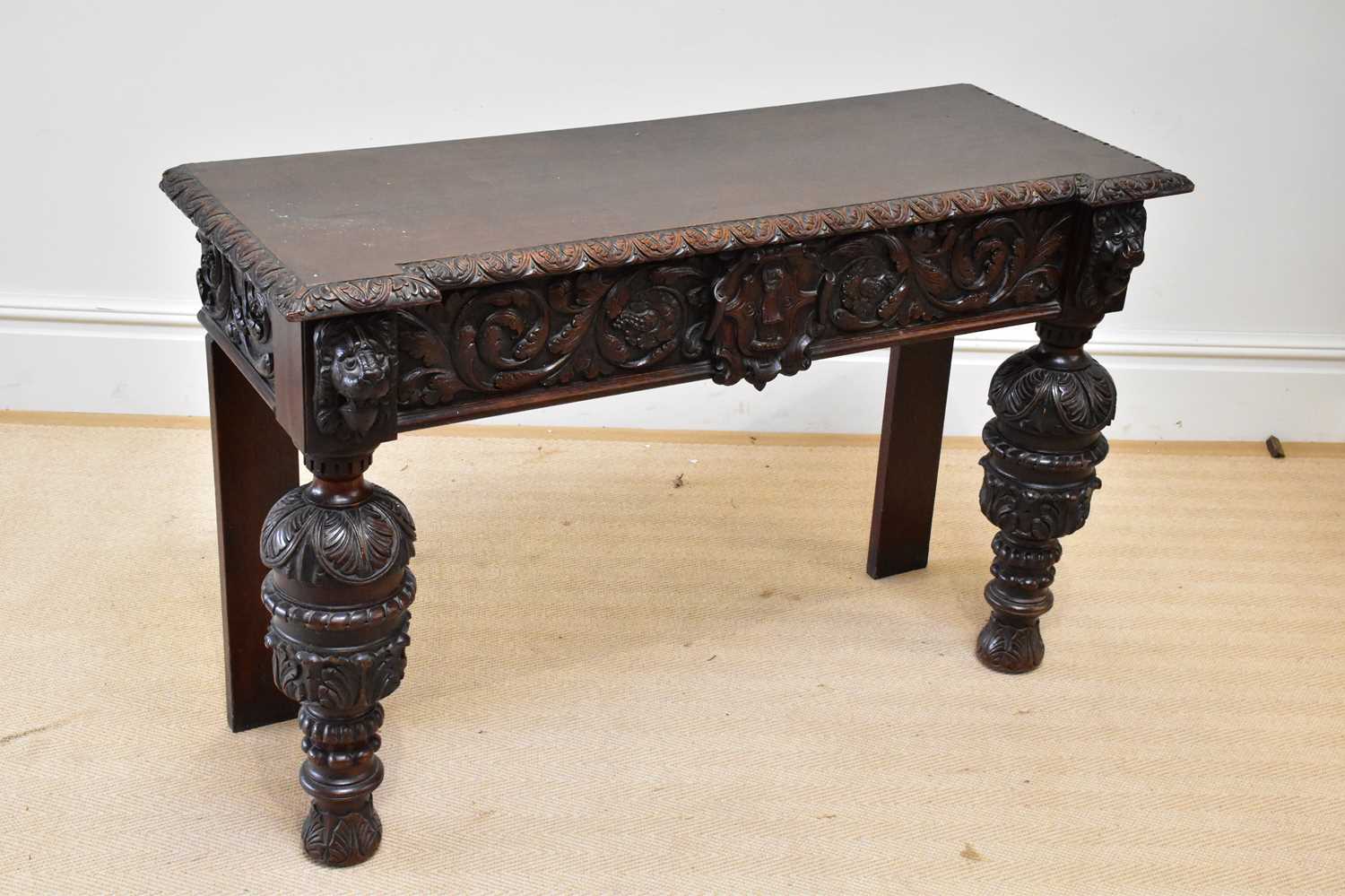 A 19th century Flemish style carved oak side table, height 88cm, width 121cm, depth 47cm.