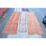 A Caucasian hand woven wool rug, worked with a geometric design against a purple ground, 180 x 97cm,