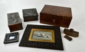 A Victorian amboyna writing slope with inlaid crossbanding, two carved oak boxes, a carved vesta