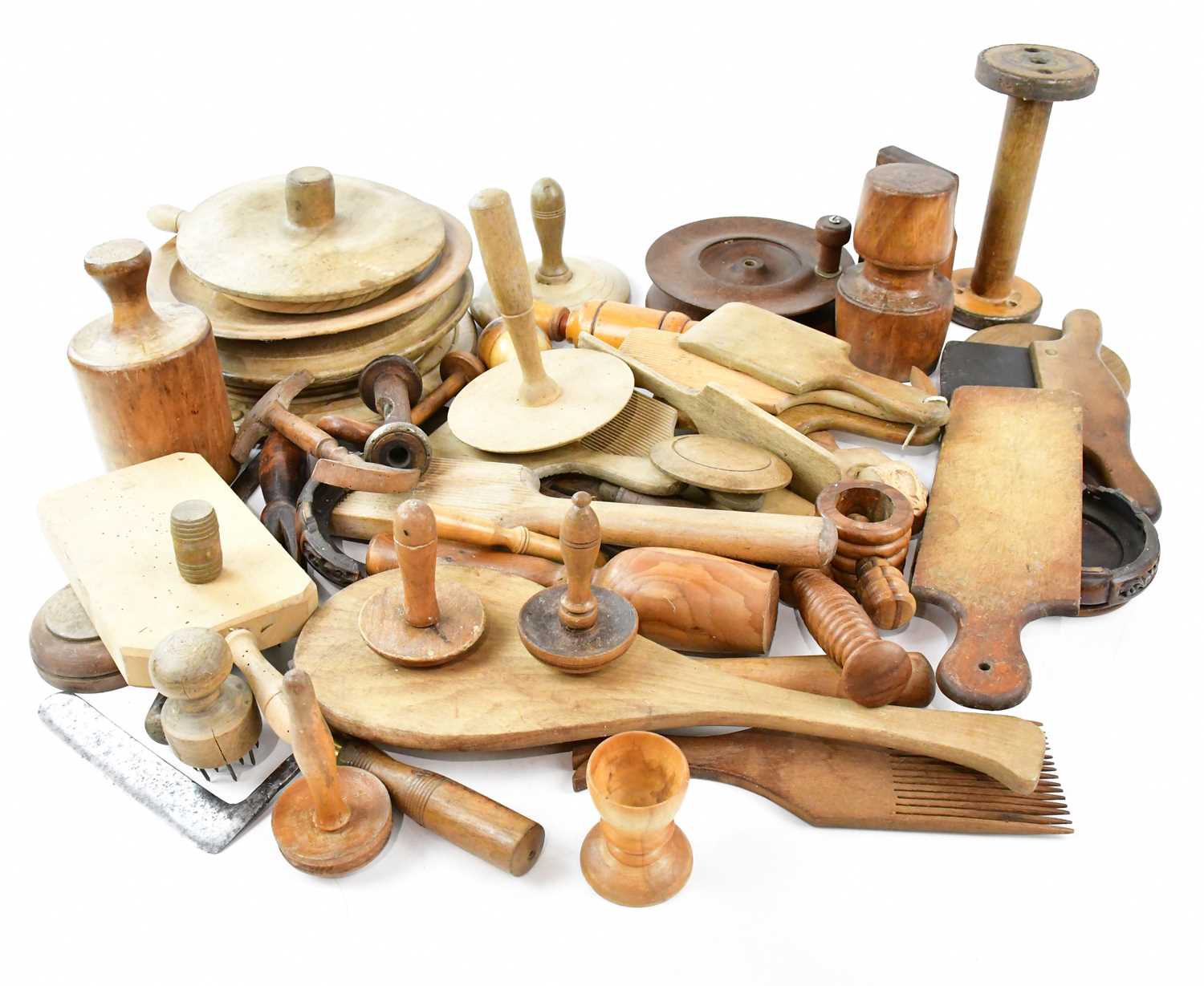 A collection of 19th/early 20th century treen including breadboards, butter pats, etc.