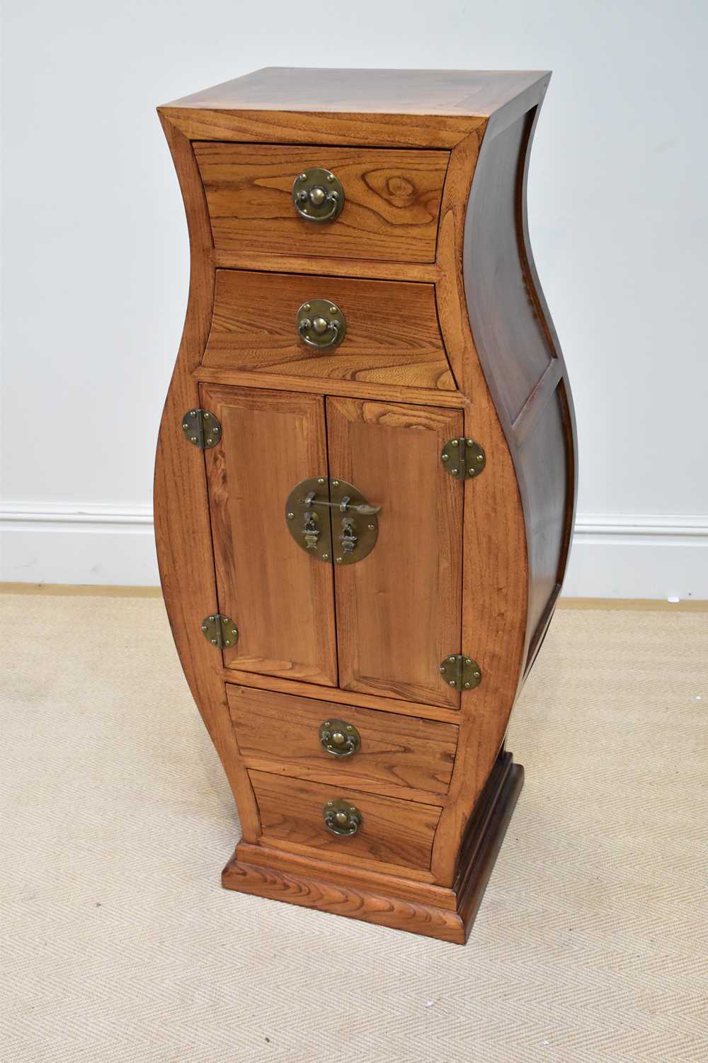 A modern Chinese rosewood vase shaped cabinet with an arrangement of four drawers and two panelled