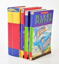 J K ROWLING; a group of four Harry Potter books comprising of The Philosopher's Stone, two copies of
